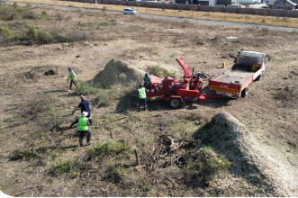 ChipperMan crew clearing land with industrial wood chipper